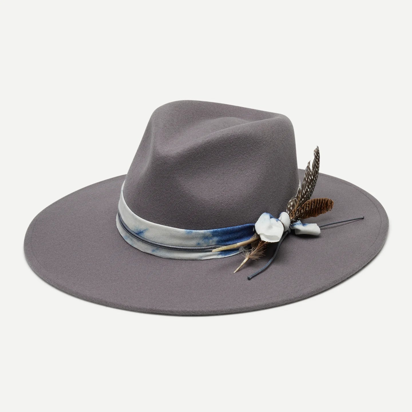 Gray fedora hat with decorative band and feathers on a light gray background