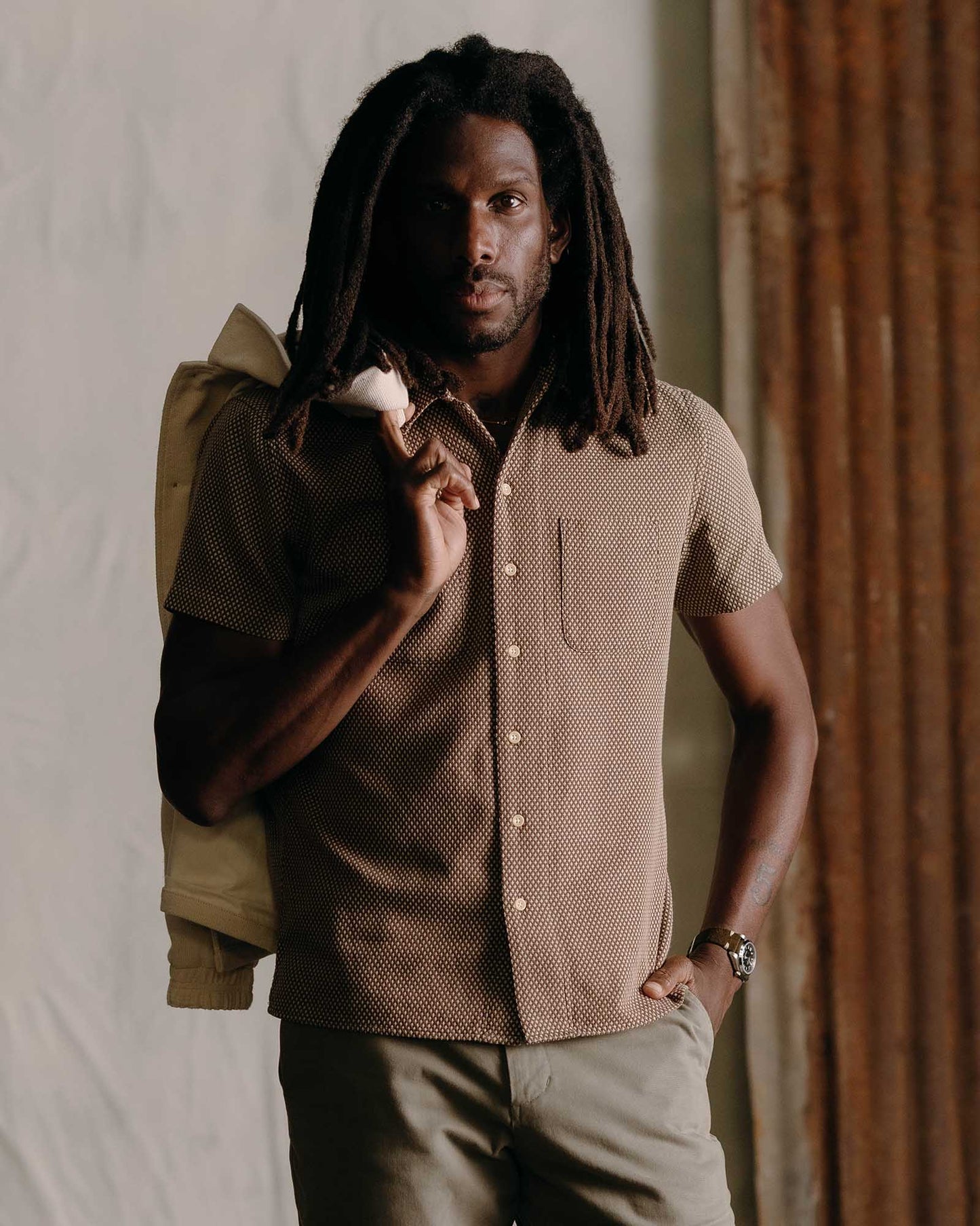 man wearing taylor stitch brand shirt the conrad in cocoa posing for camera in stylish mens fashion