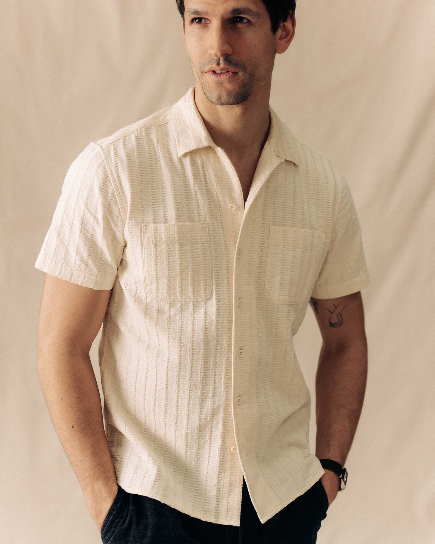man wearing taylor stitch brand short sleeved shirt the conrad in vintage white