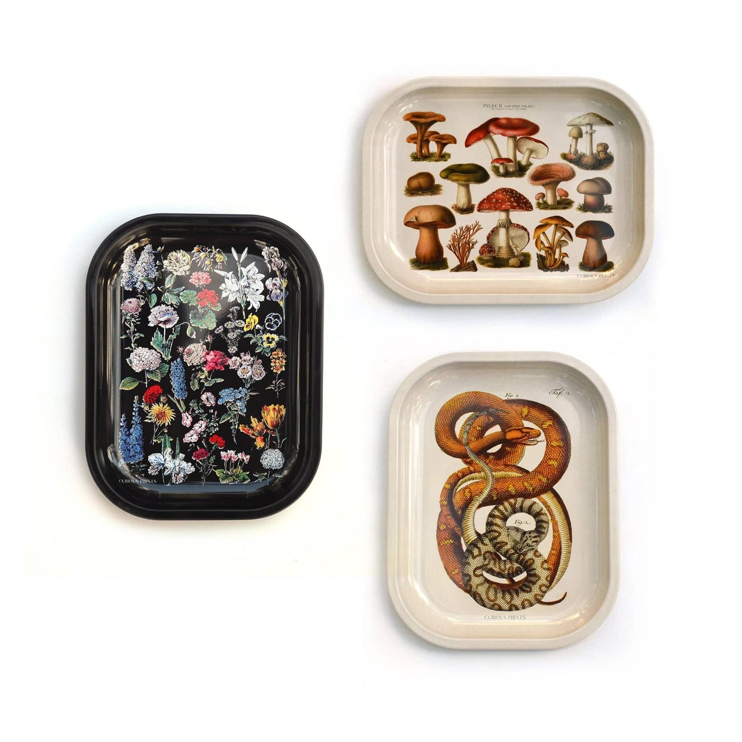 three different trays and patterns from the brand curious prints; trays to be used as ritual trays; florals, mushrooms, and snakes