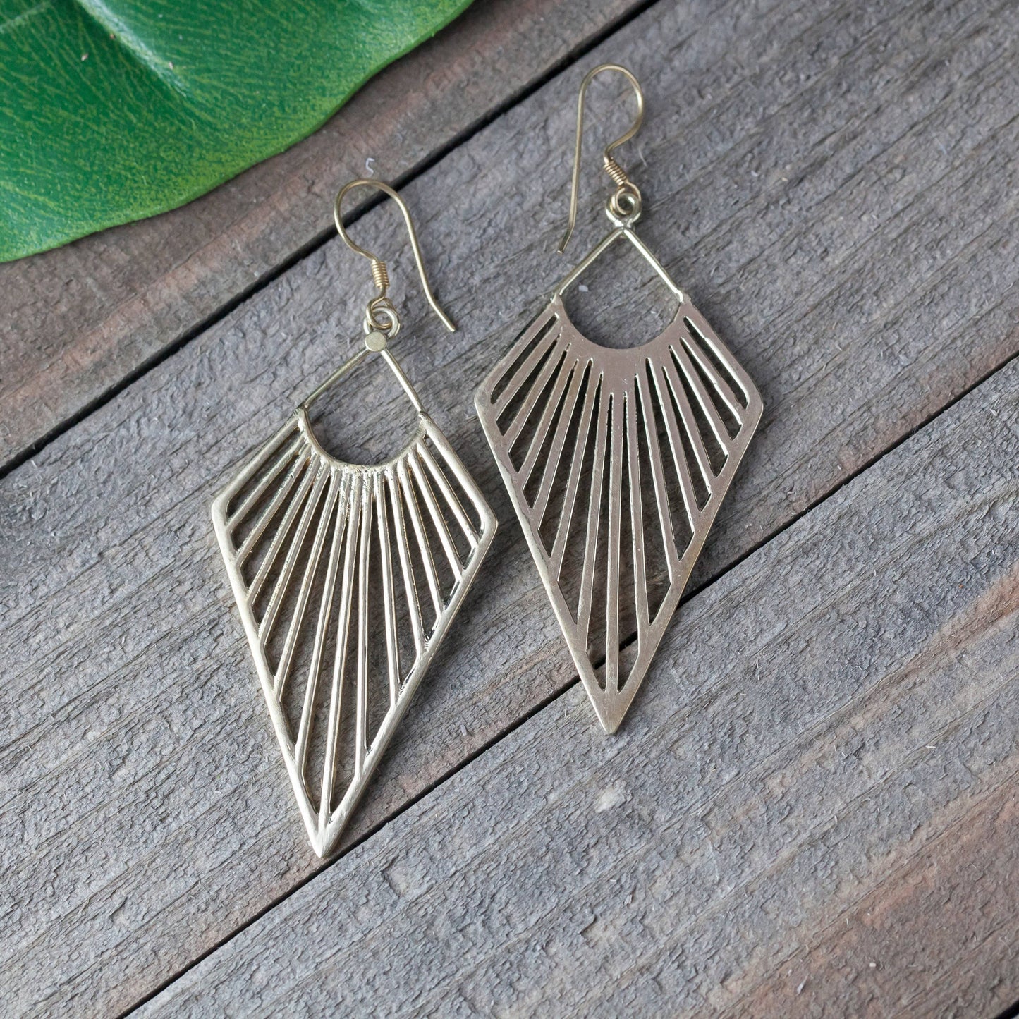 Pair of geometric earrings on a wooden surface
