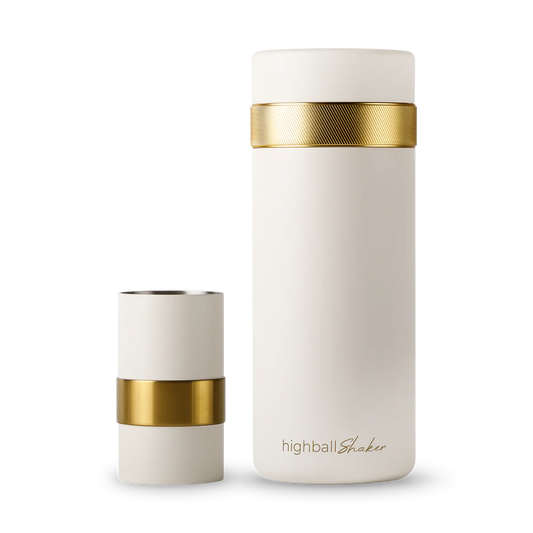 Two white highball shakers with gold bands on a white background, featuring the brand 'highballShaker'.