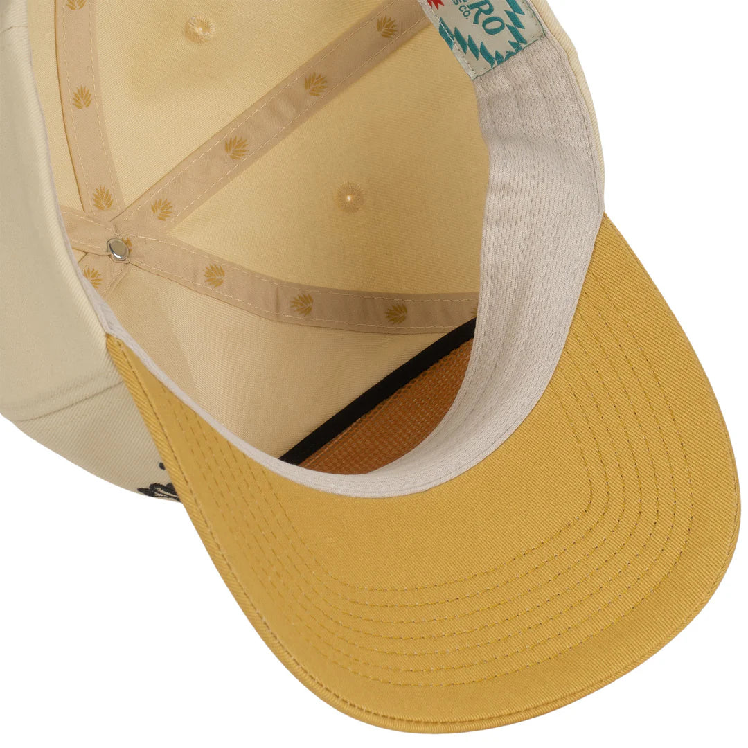 Close-up of a yellow cap with beige interior on a white background
