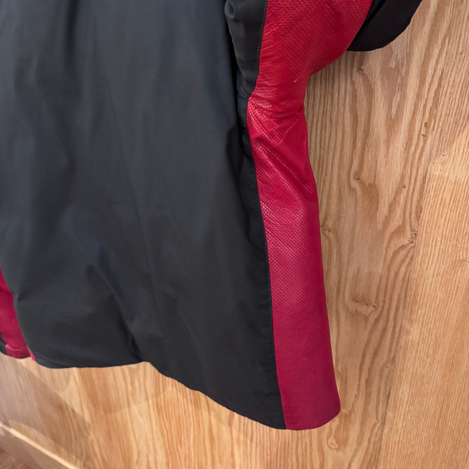 Black and red jacket on a wooden surface