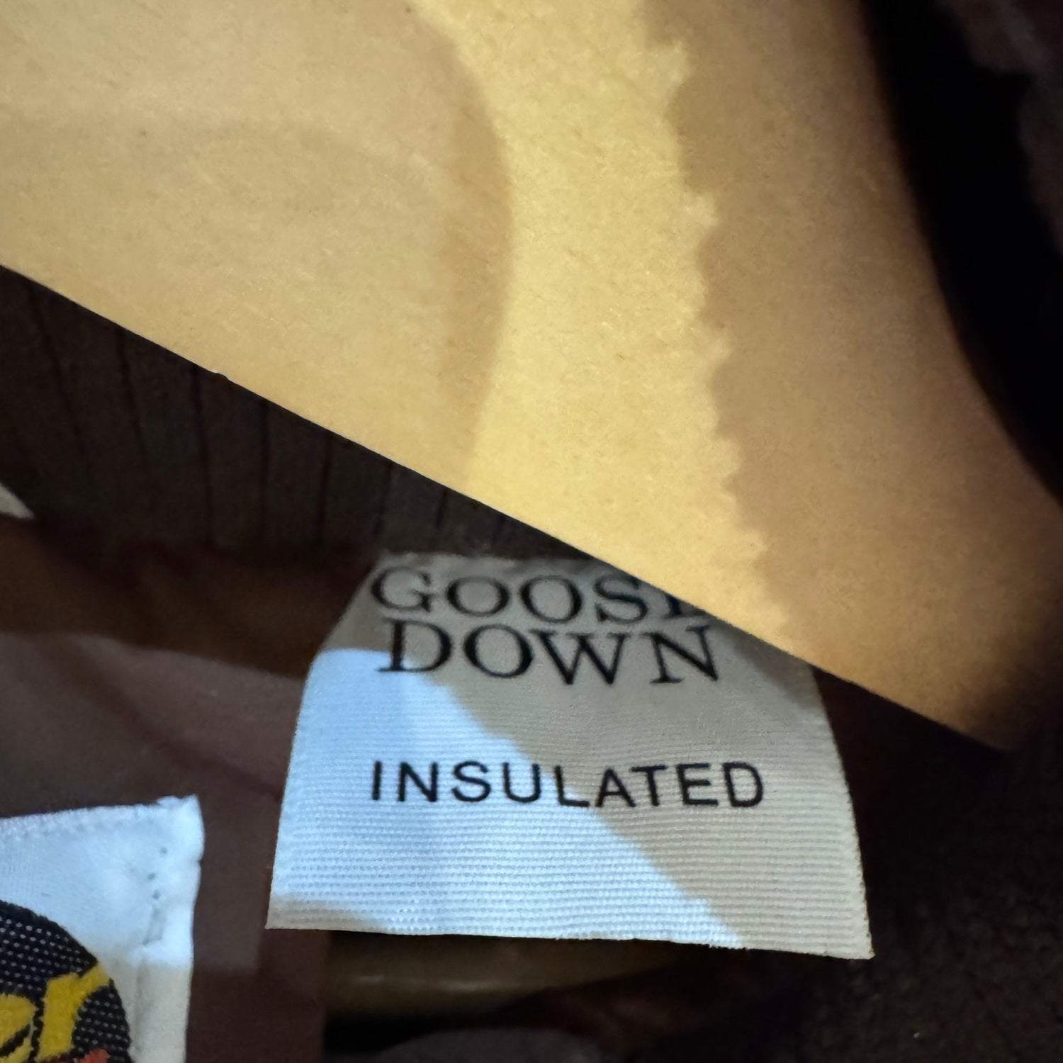 Label indicating 'Goose Down Insulated' on a garment