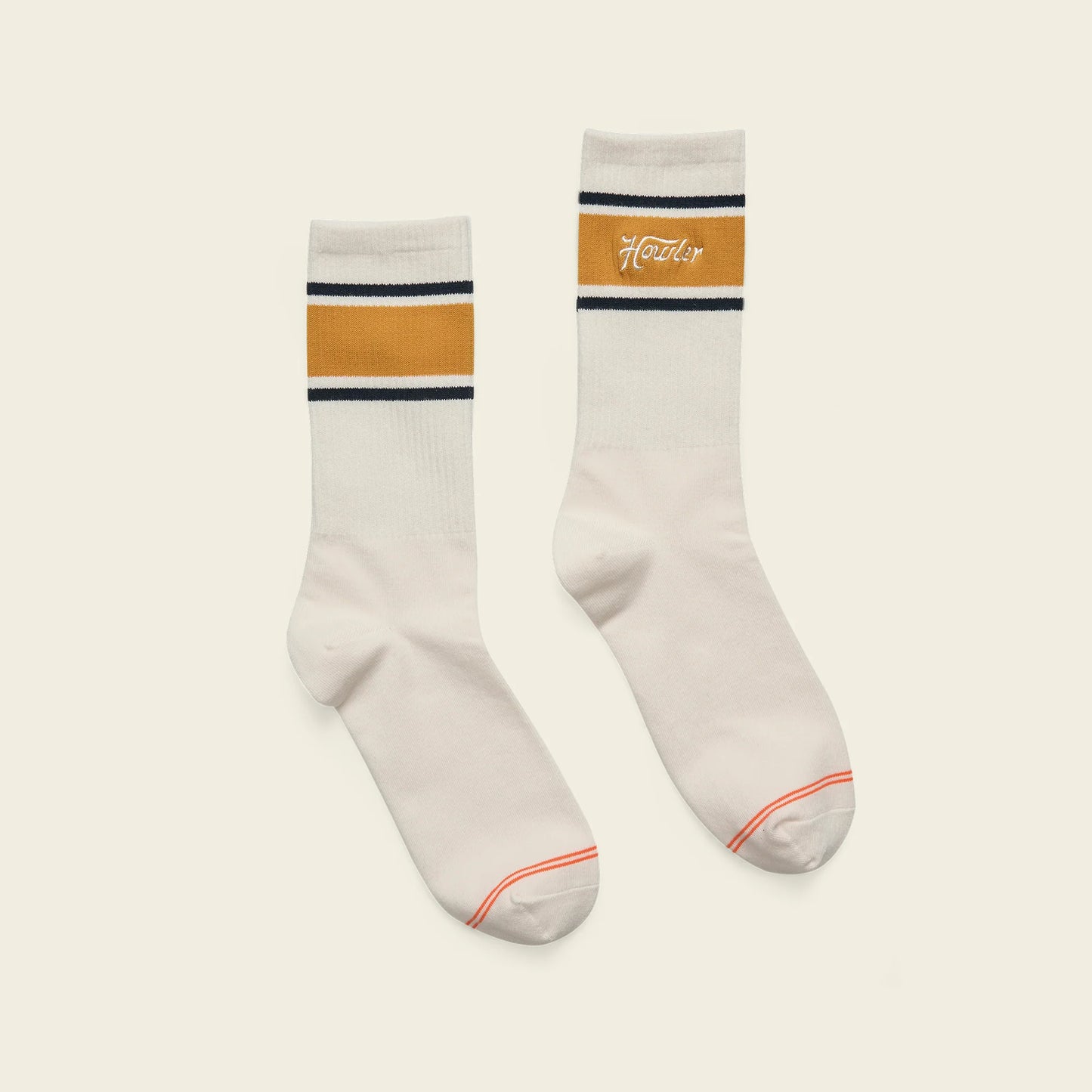 Two socks with striped design on a light beige background
