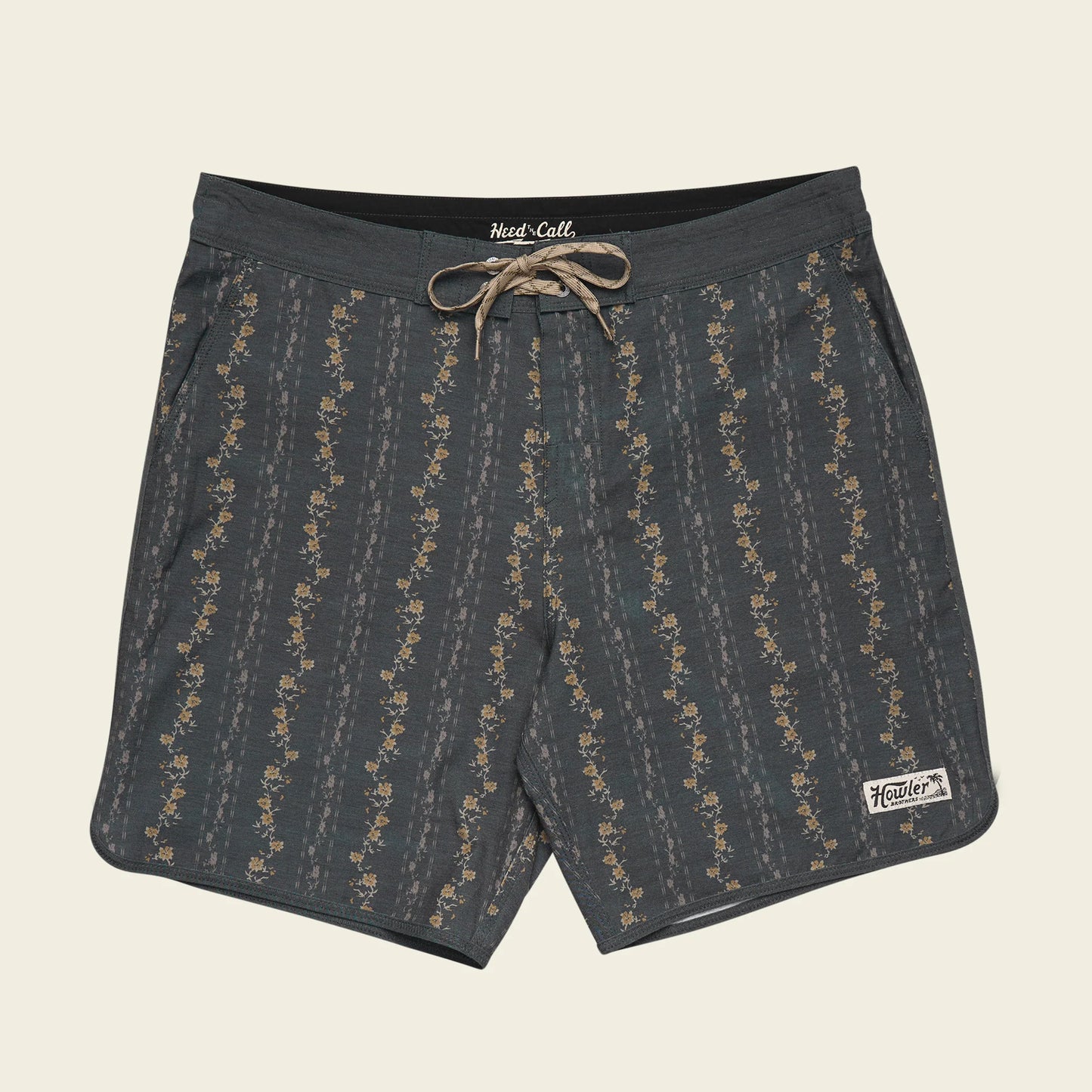 Dark gray shorts with a subtle pattern on a beige background