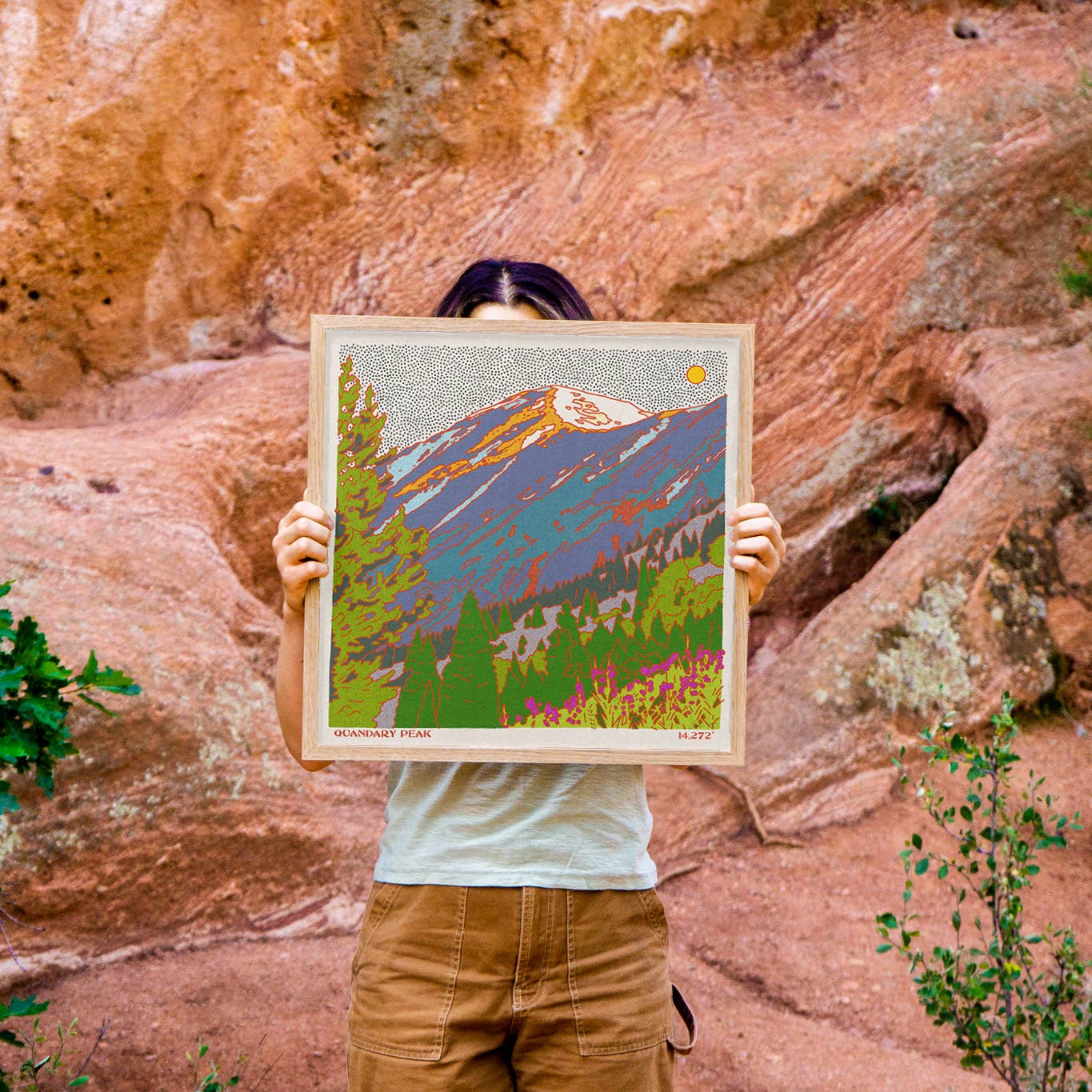 Caroline-Clark-art-print-mstgoods-colorful-landscape-art-4 artist holding her art in nature