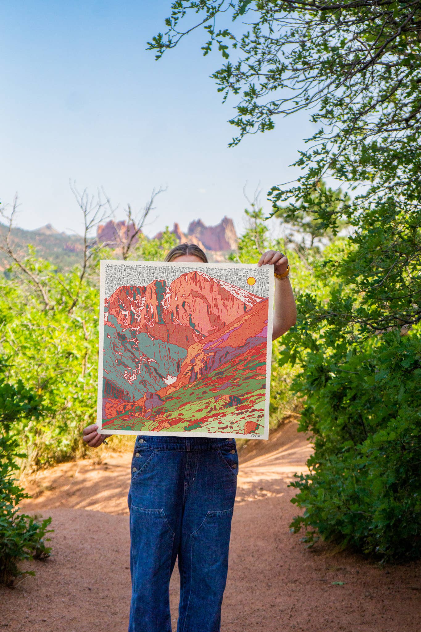 Caroline-clark-art holding her artowrk