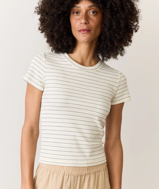 Woman wearing a striped t-shirt against a plain background