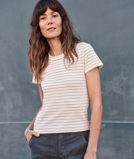 Woman wearing a striped shirt against a gray background