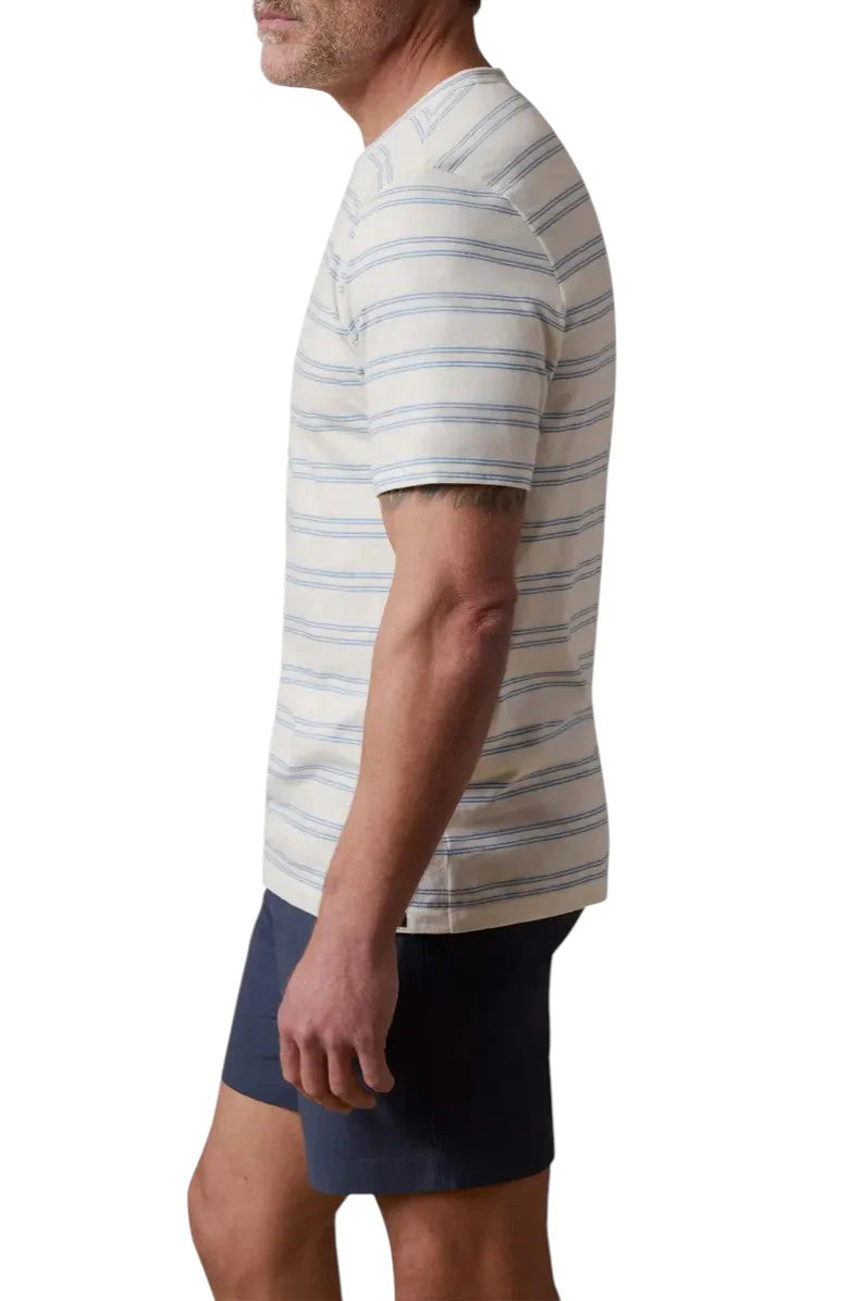 Man wearing a striped shirt and navy shorts on a white background