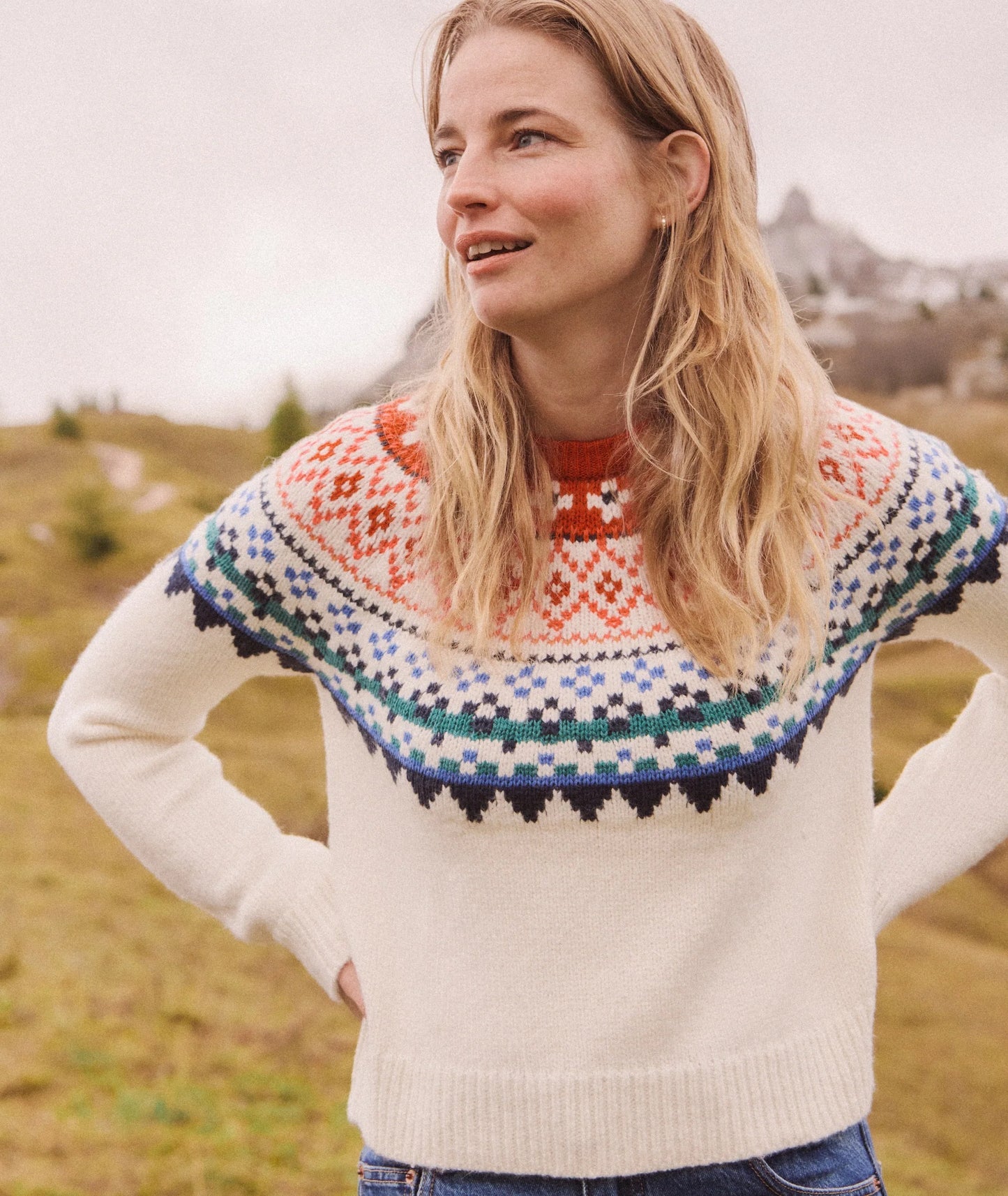 Woman wearing a colorful knitted sweater in a natural setting