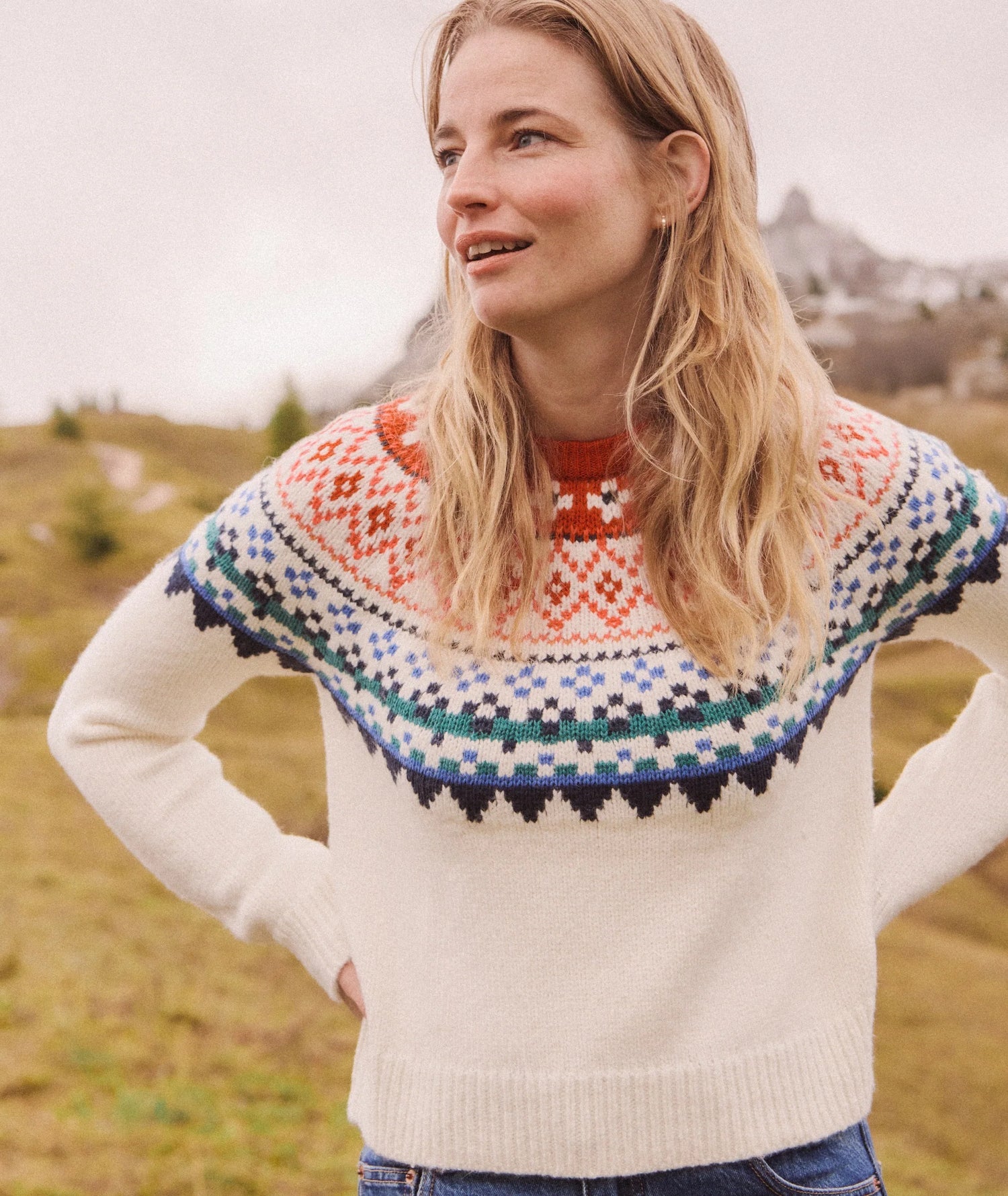 Woman wearing a colorful knitted sweater in a natural setting