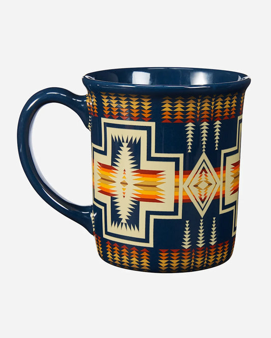 Navy blue mug with geometric pattern on a white background