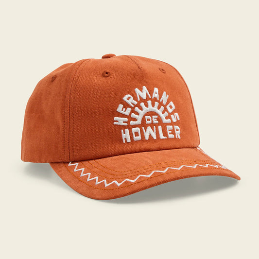 Orange cap with white embroidered text on a beige background