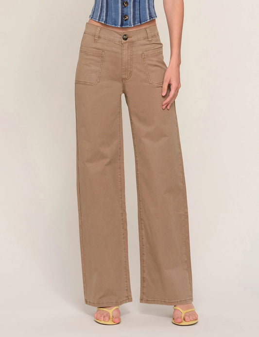 Person wearing beige wide-leg pants on a plain background