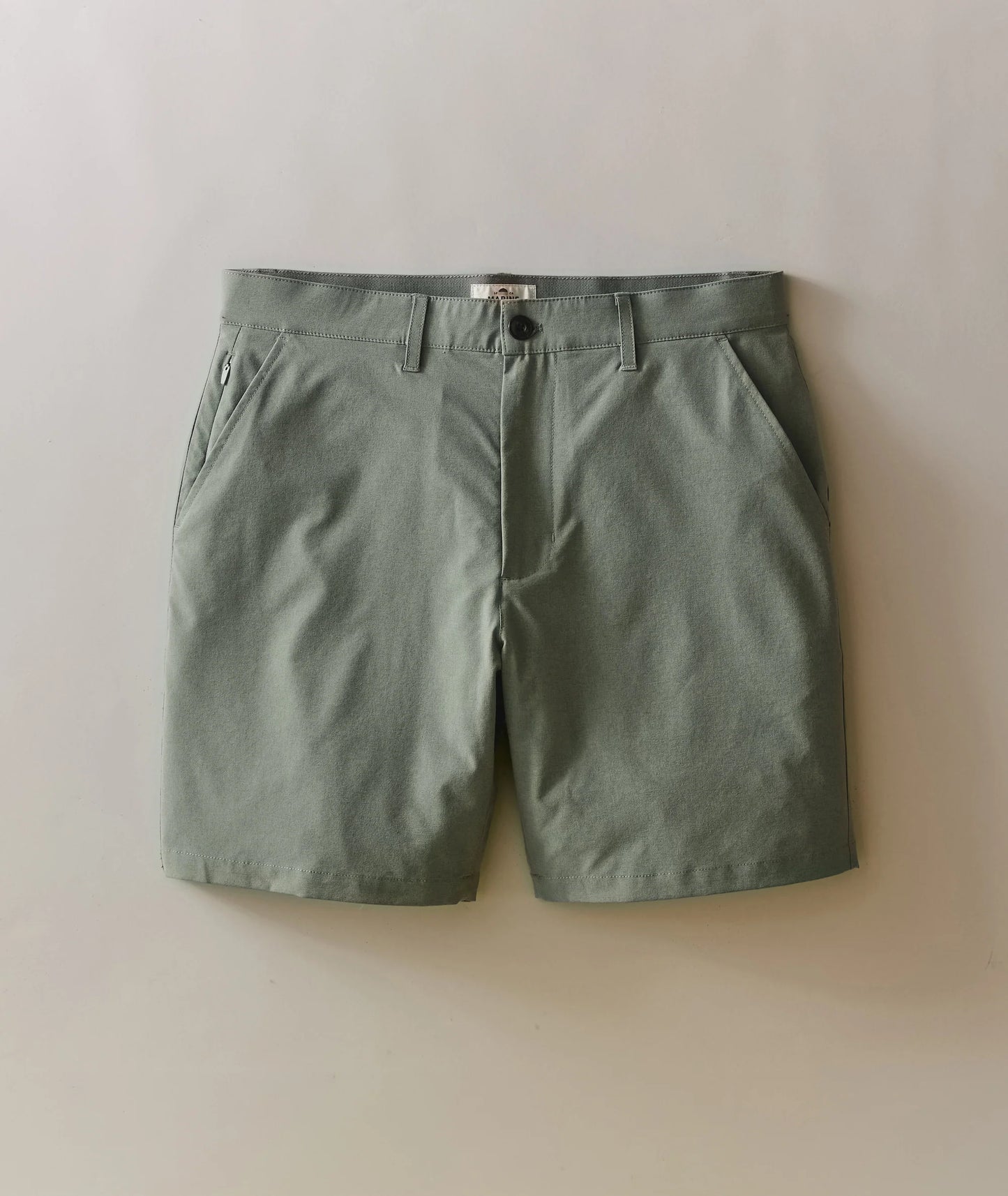 Green shorts on a light beige background