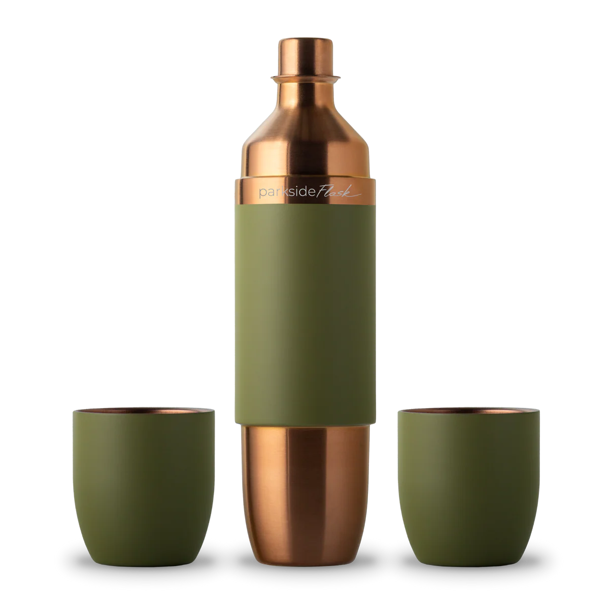 Green and copper cocktail shaker with two matching cups on a white background