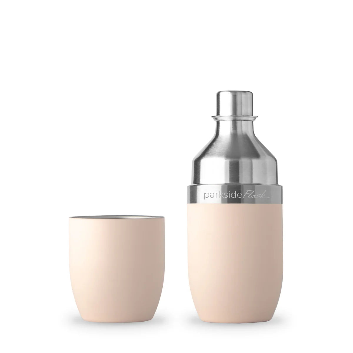 Beige cocktail shaker and glass with silver top on a white background