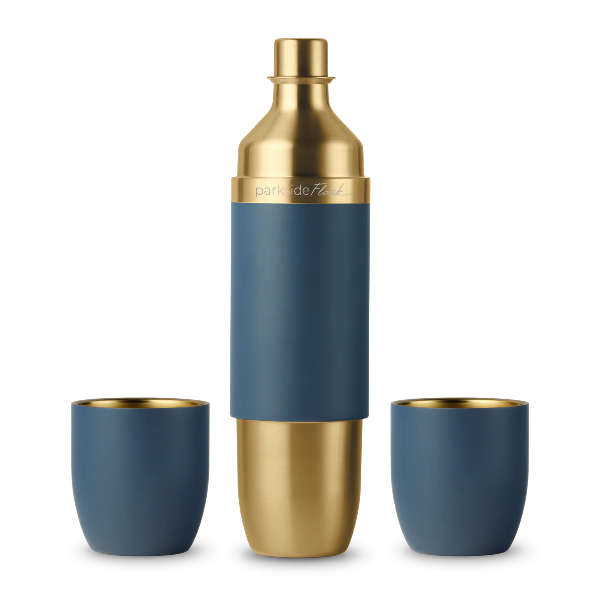 Blue and gold cocktail shaker with two matching cups on a white background