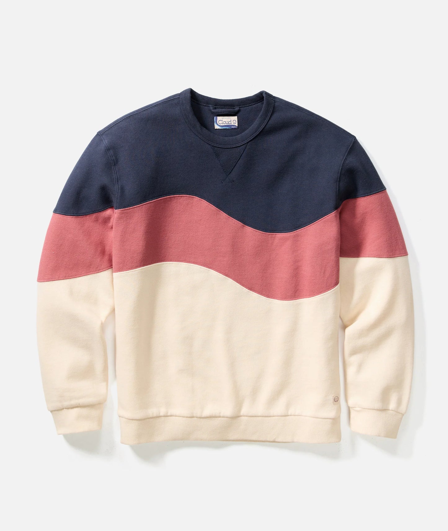 Color-blocked sweatshirt with navy, red, and beige sections on a light gray background
