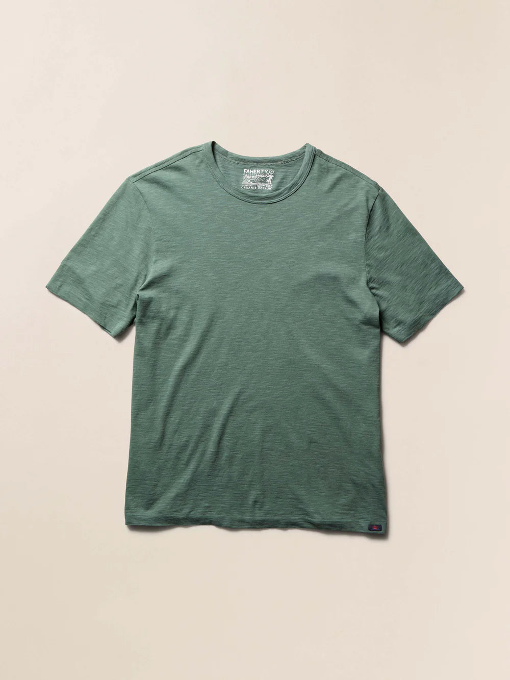 Green t-shirt on a beige background
