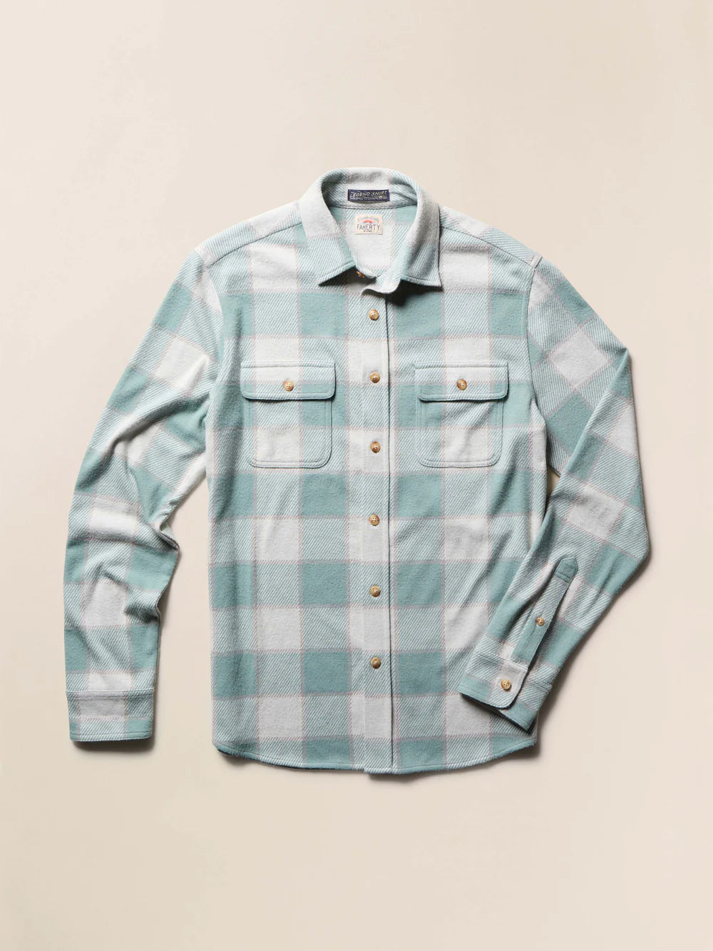 Plaid shirt with a green and white pattern on a beige background