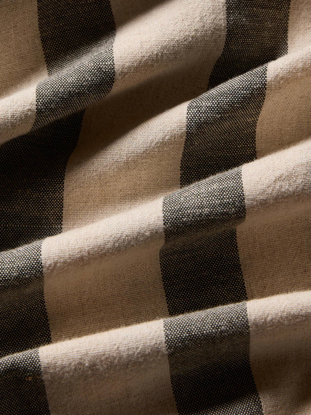 Close-up of a checkered fabric with black and beige squares.