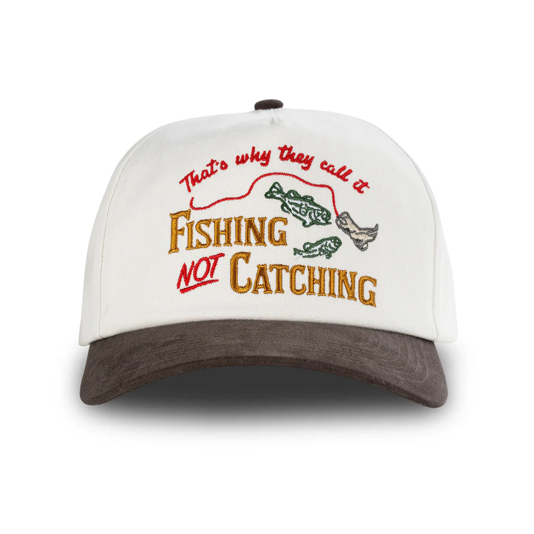 White cap with brown brim featuring fishing-themed text and graphics on a white background