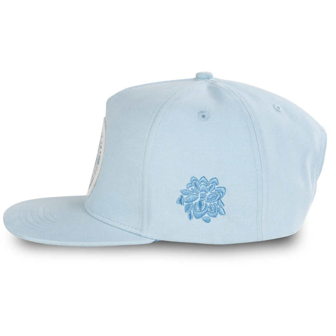 Light blue cap with a decorative emblem on a white background