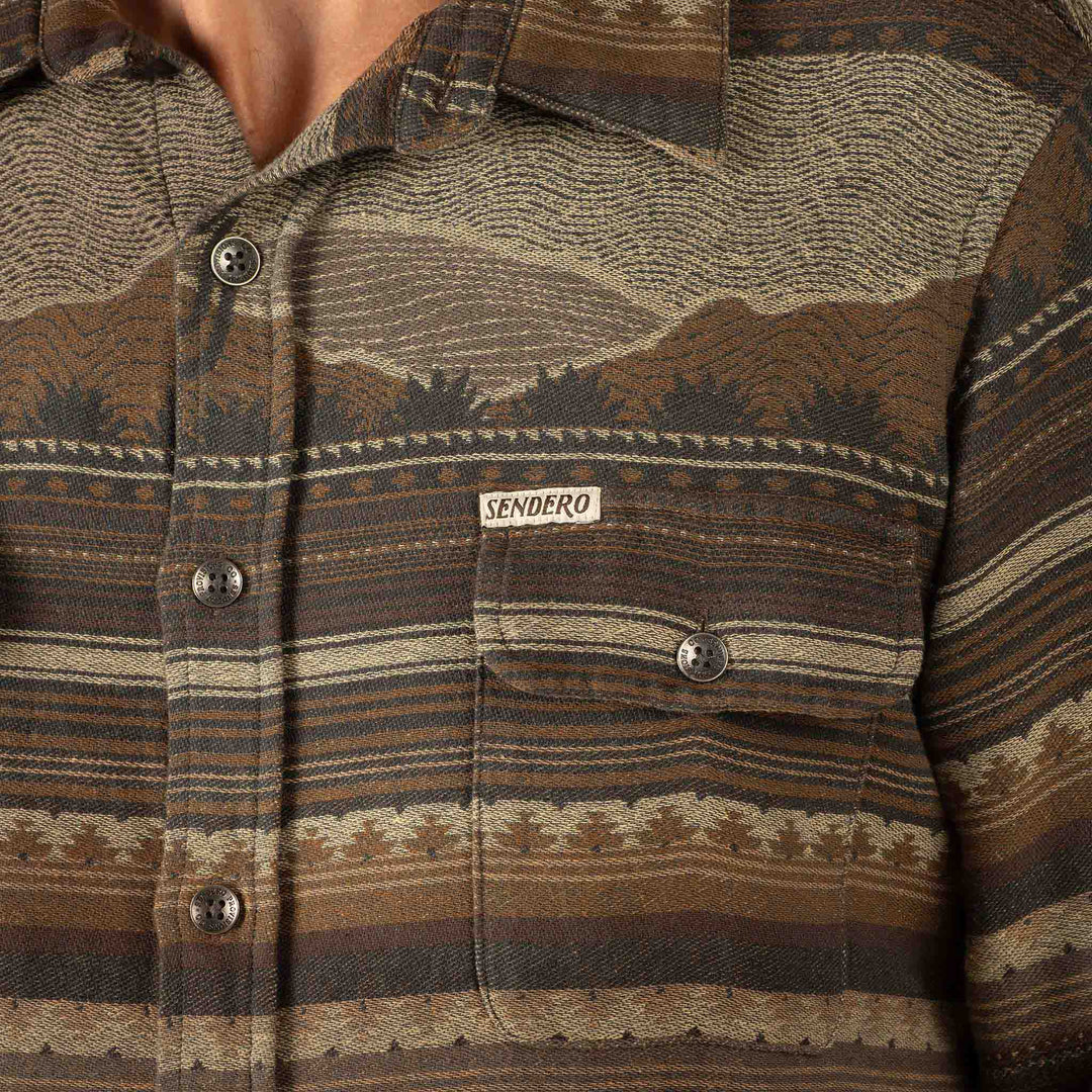 Close-up of a brown and beige patterned shirt with 'Sendero' branding.