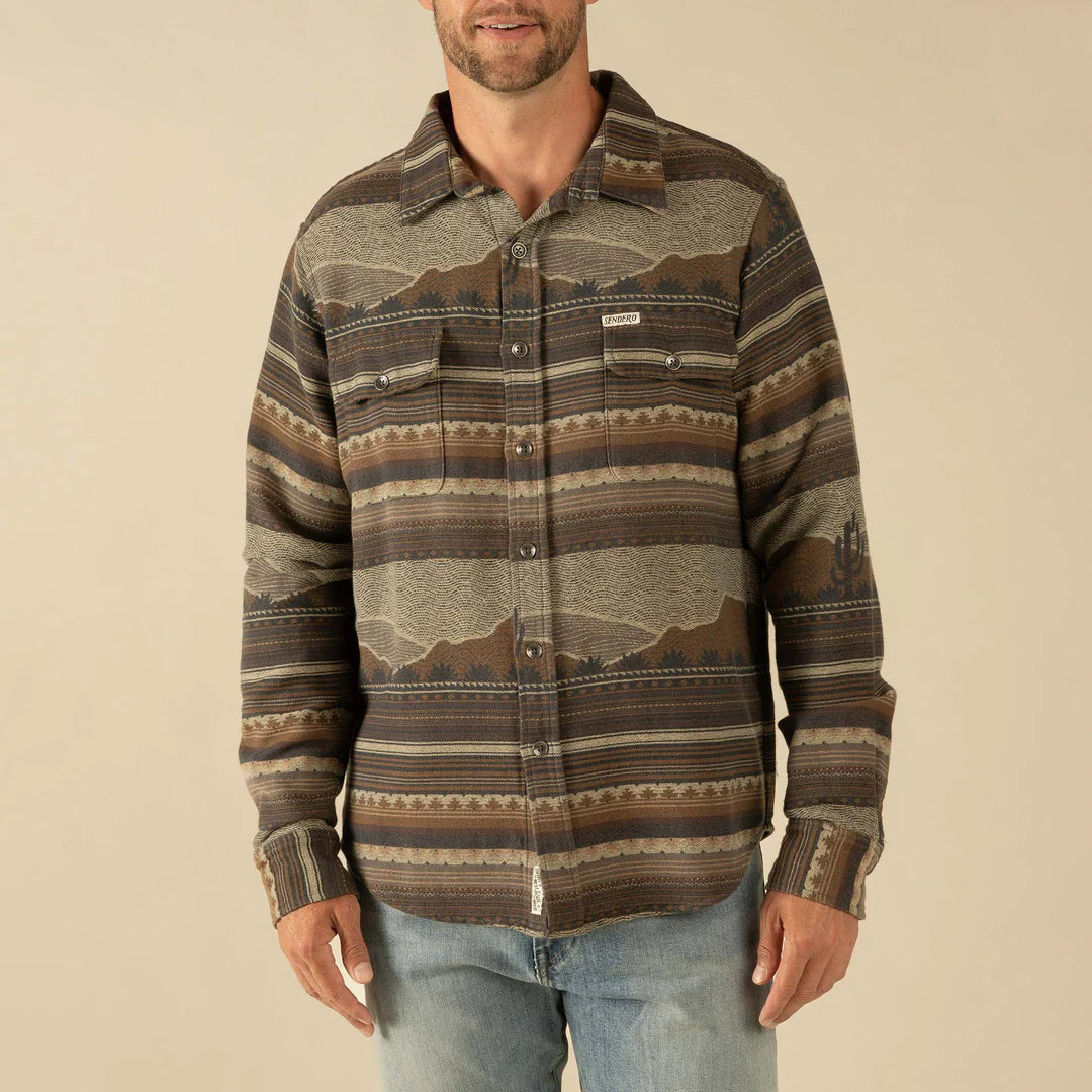 Man wearing a patterned shirt with a beige background