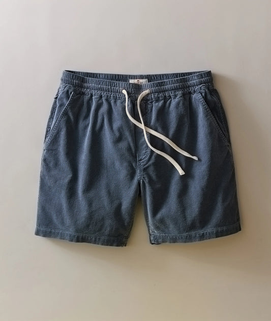 Blue shorts with a white drawstring on a beige background