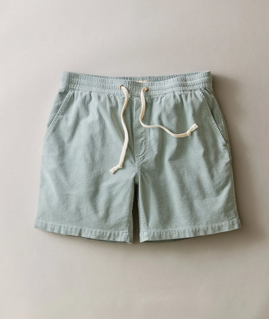 Light blue shorts with a white drawstring on a beige background