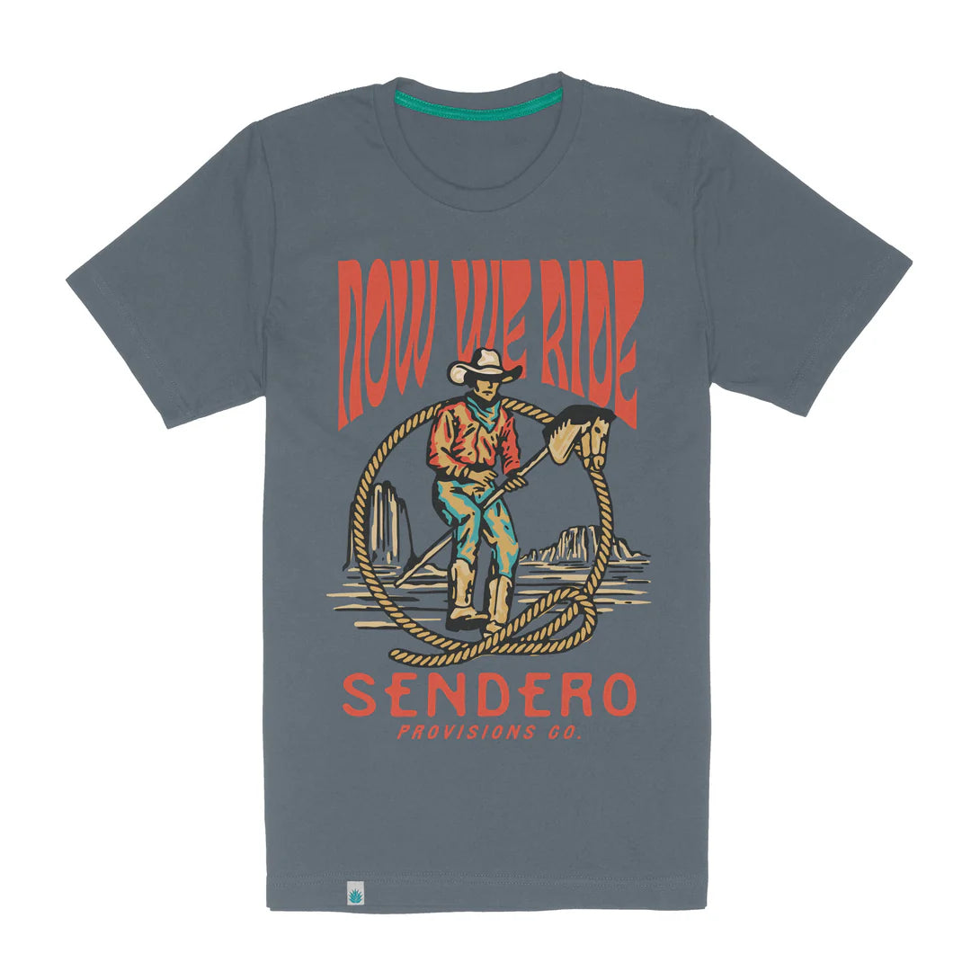 Gray t-shirt with a graphic of a cowboy and the text 'Now We Ride Sendero' on a white background