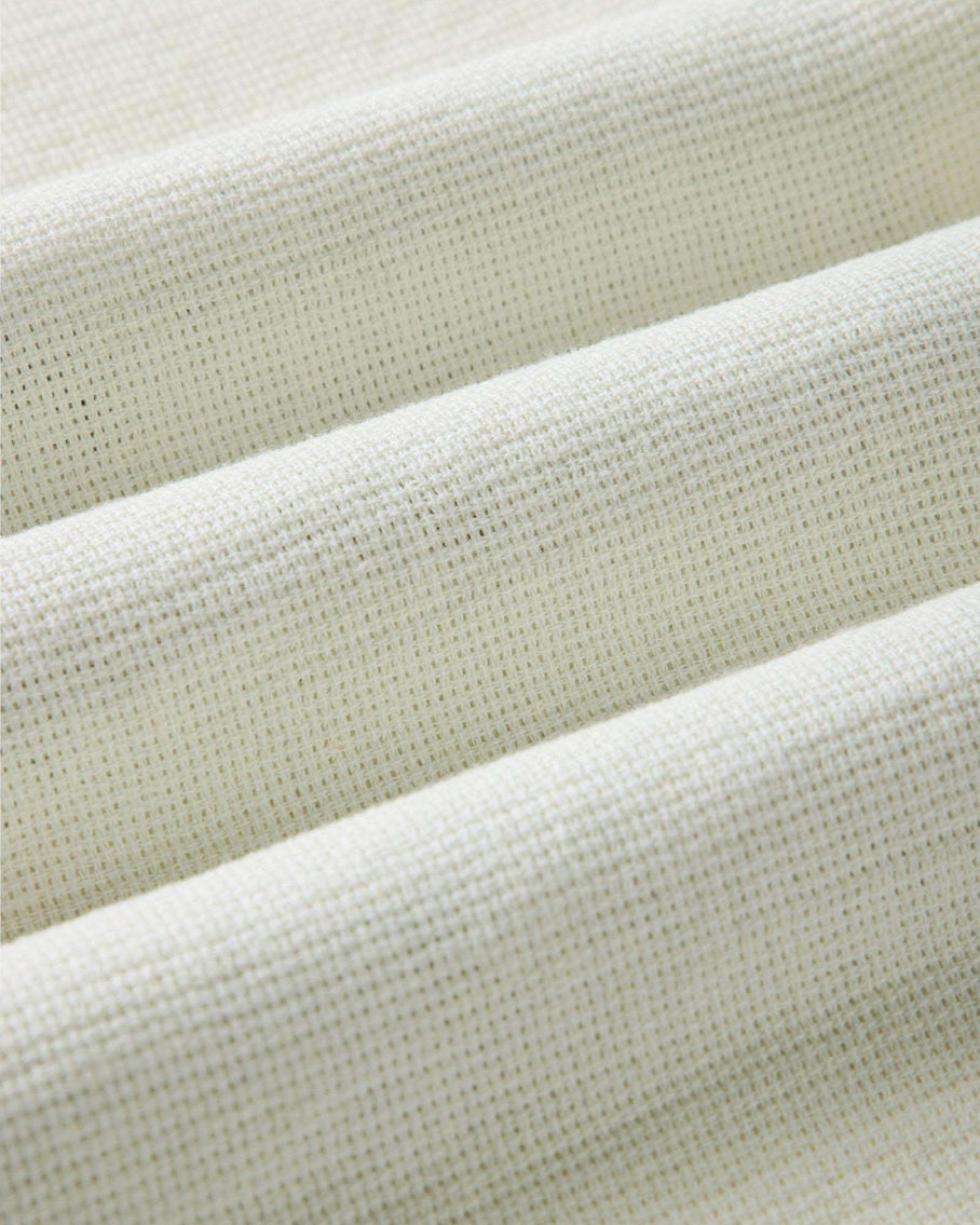 Close-up of beige fabric with a textured pattern