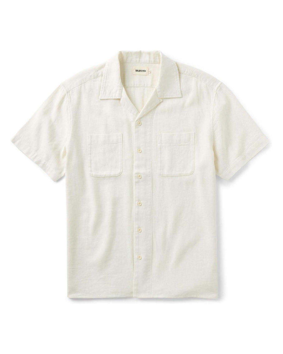 White short-sleeve shirt with button details on a white background