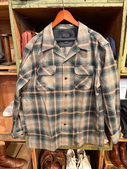 Plaid shirt hanging on a wooden rack with shoes below