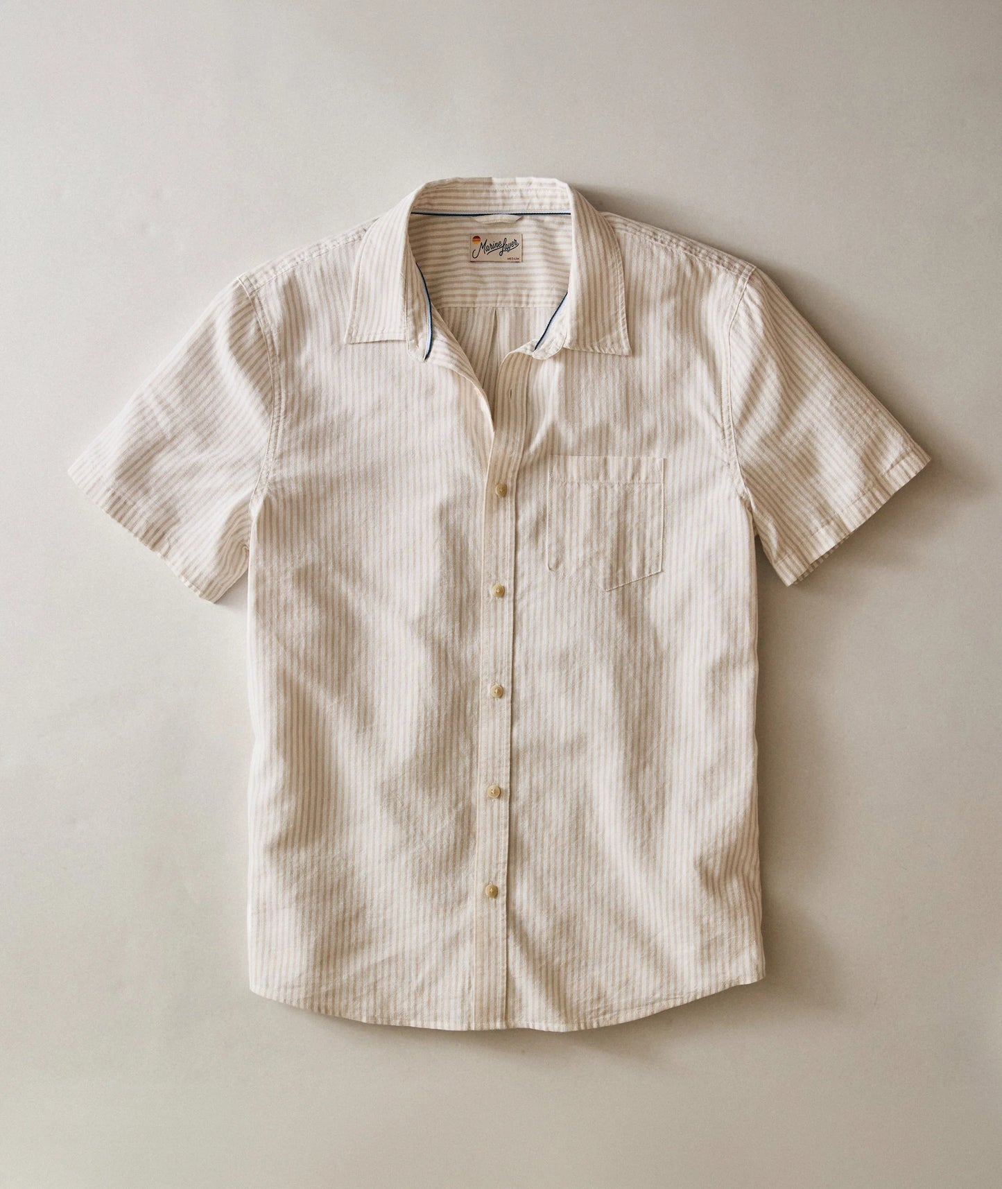 Beige short-sleeve shirt on a light beige background