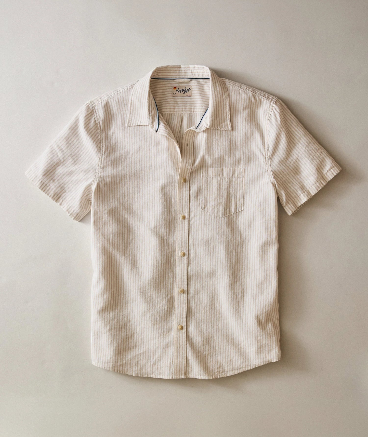 Beige short-sleeve shirt on a light beige background
