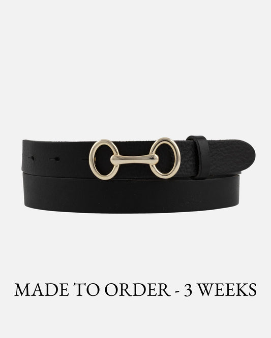 Black belt with gold horsebit buckle on a white background