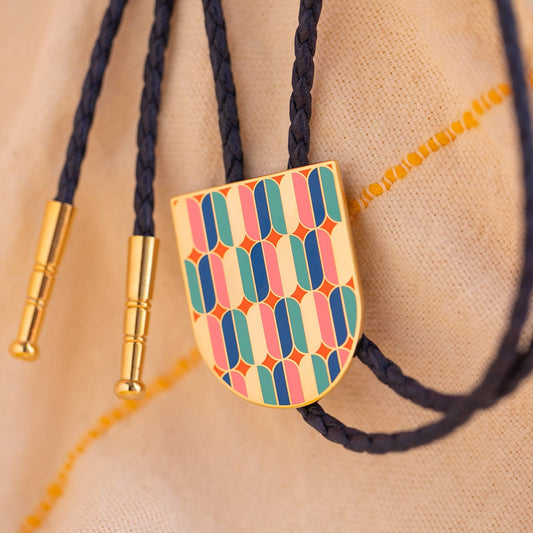 Colorful bolo tie with geometric pattern on a beige background