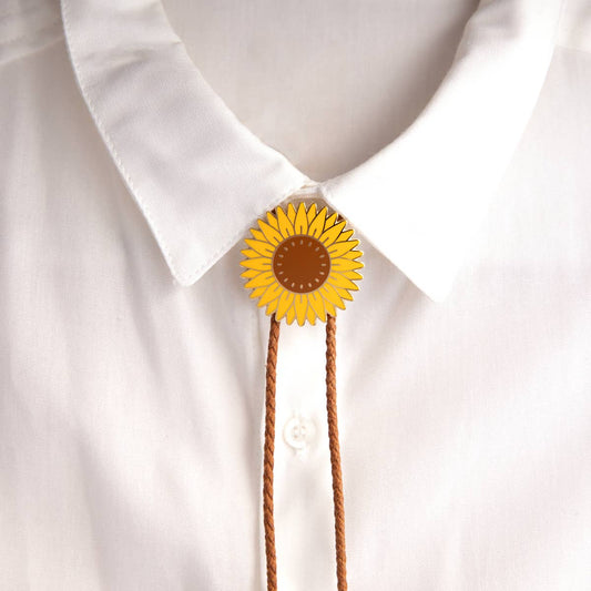 Yellow sunflower-shaped bolo tie on a white shirt