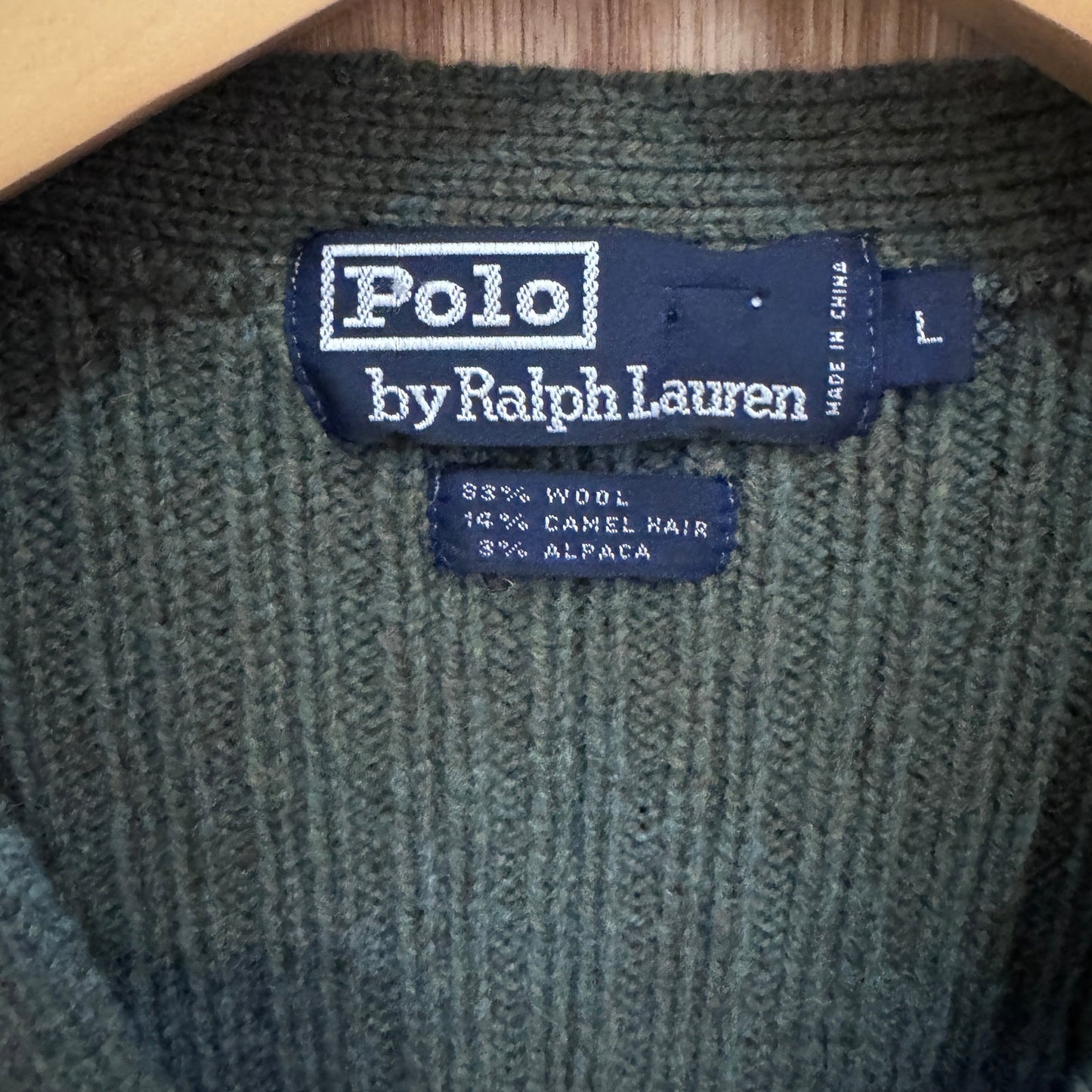 Polo by Ralph Lauren label on a green fabric background