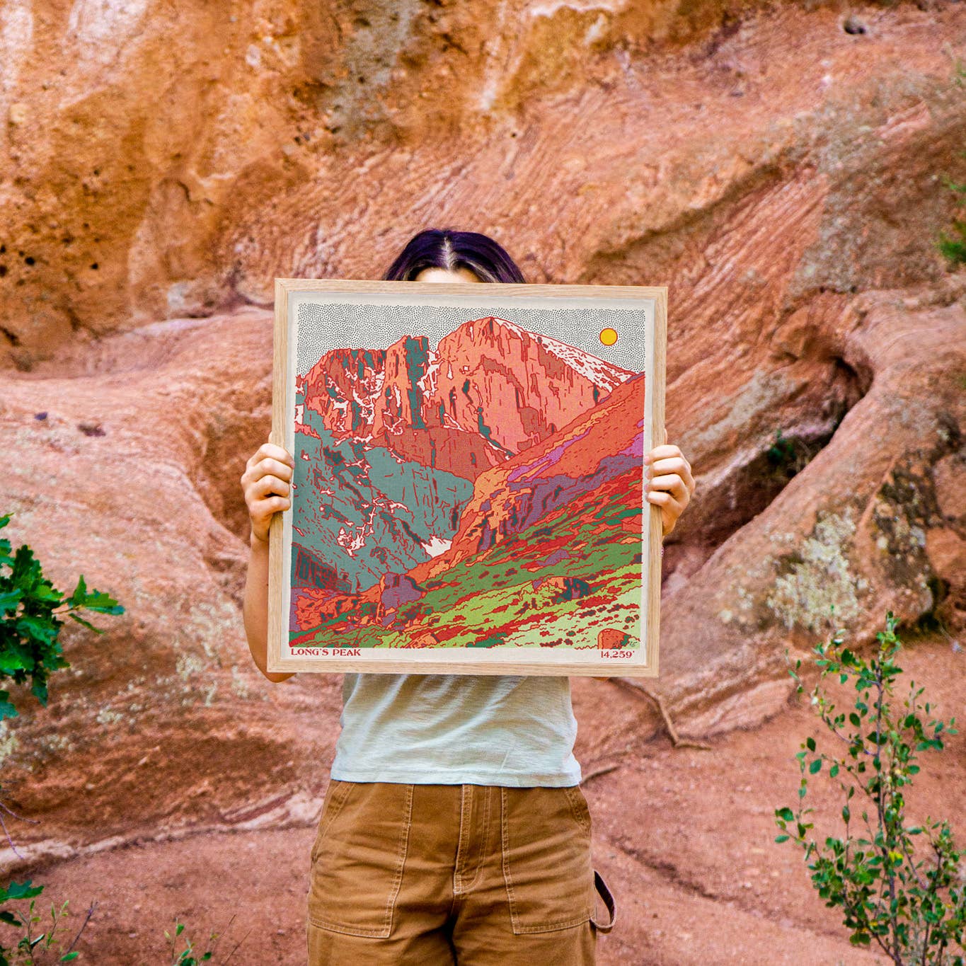 artist caroline clark holding a work of art