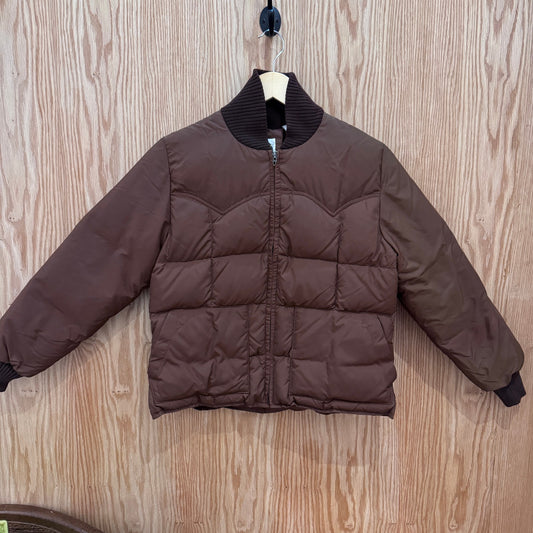 Brown puffer jacket on a hanger against a wooden background