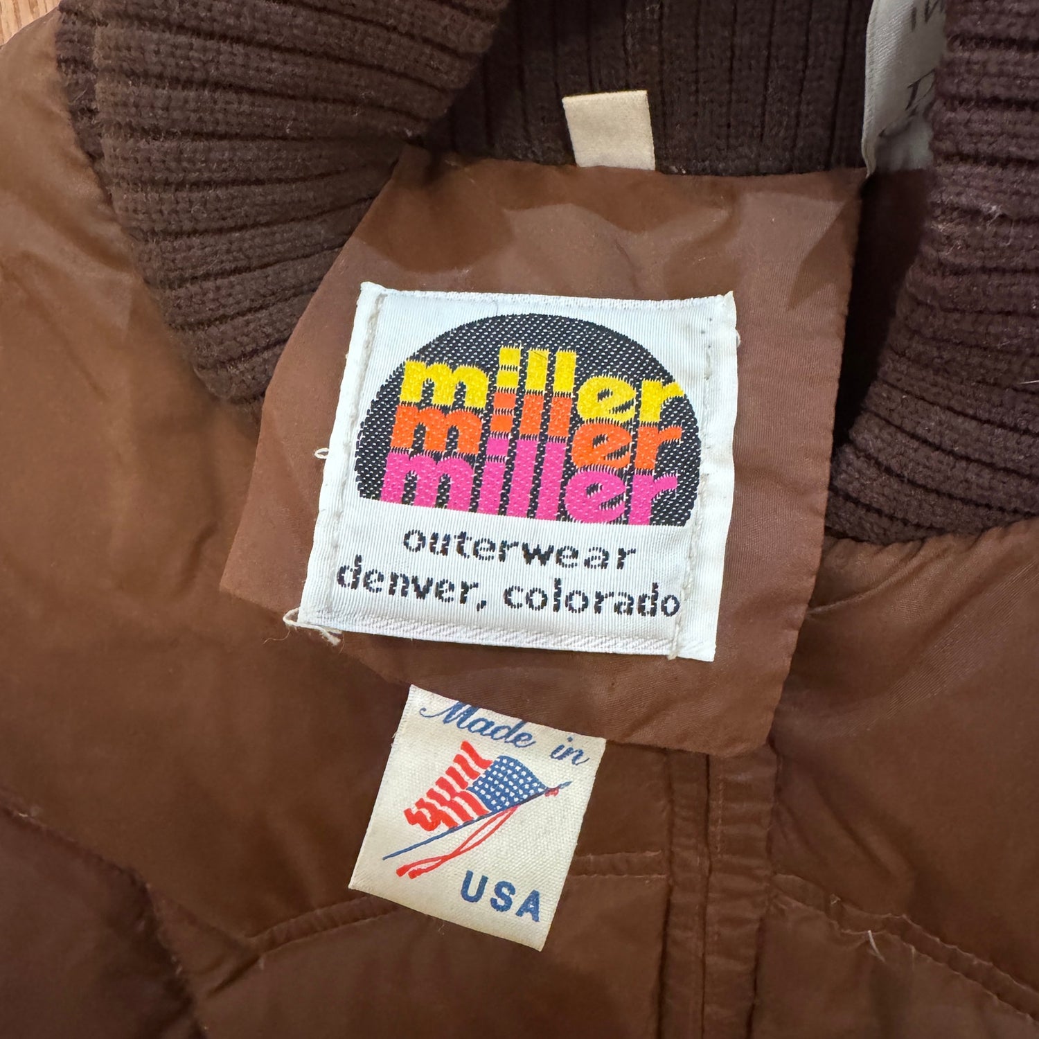 Brown jacket with 'Miller Outerwear' label and 'Made in USA' tag.