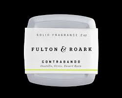 Solid fragrance container labeled 'Fulton & Roark Contrabando' on a black background