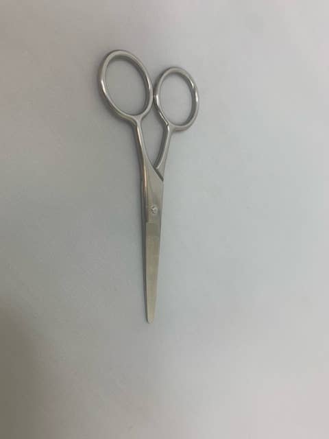 Pair of silver scissors on a white background